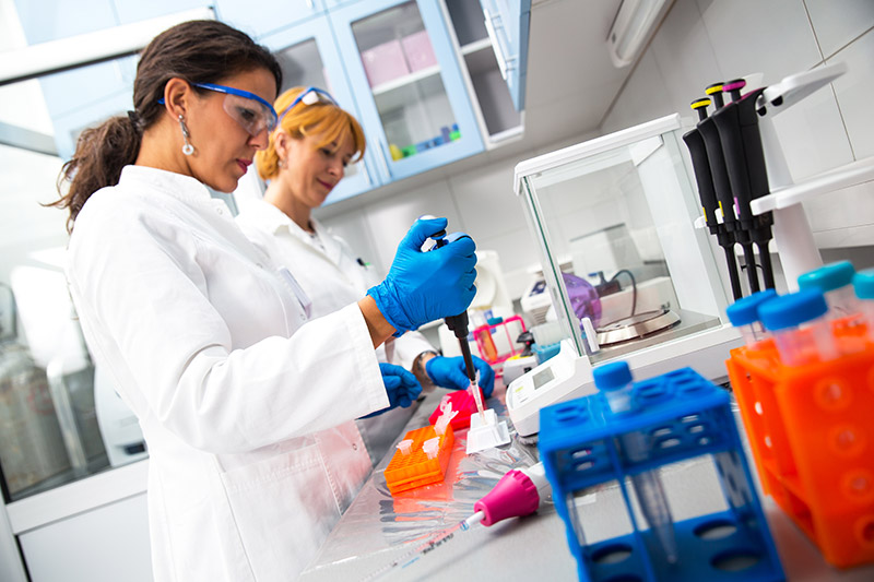 Photo of two scientists working in lab